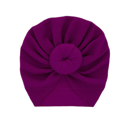 Purple knit turban on a white background