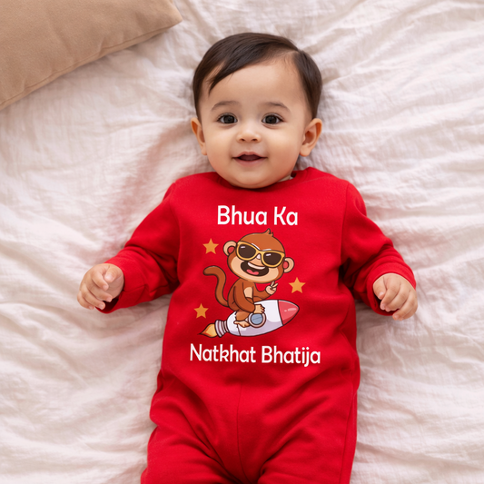 Baby wearing a red onesie with monkey design and text on a white blanket