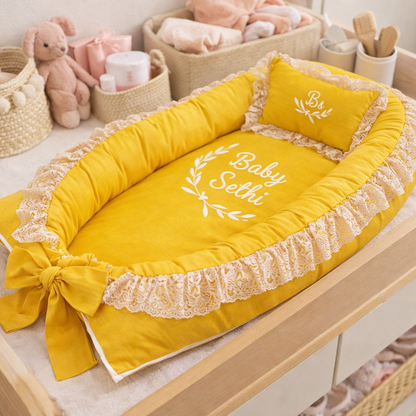 Yellow baby crib with decorative elements on a changing table