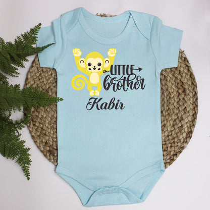 "Custom baby onesie with name and special design Rakhi."