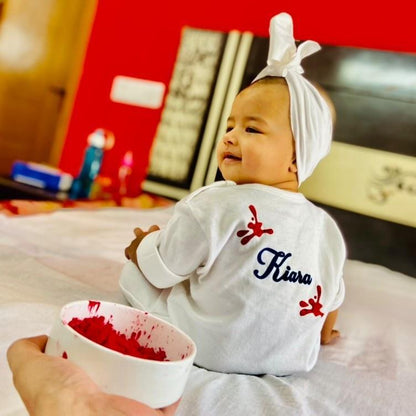 "Custom name My First Holi Organic jumpsuit for your little one."