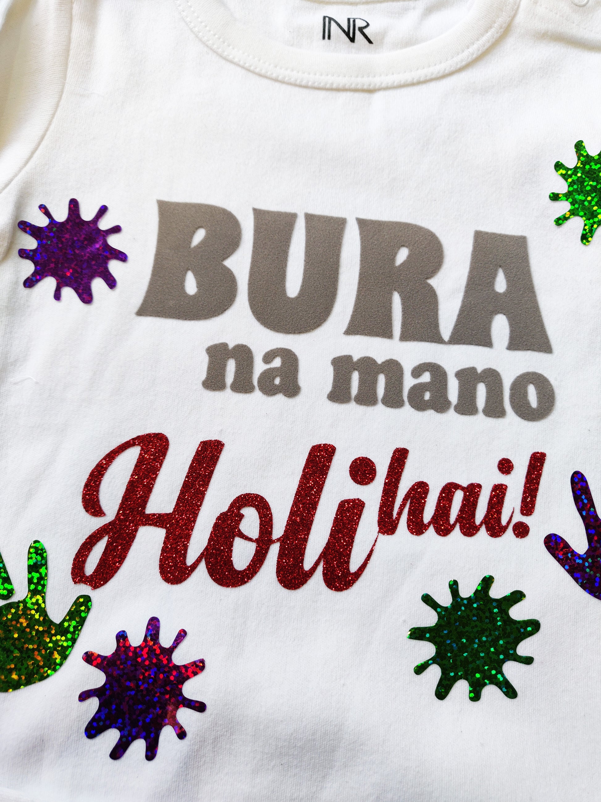 "Custom baby onesie with name and special design for holi."